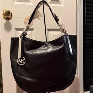 Michael Kors Shiny Black Shoulder Bag with silver accents that have orig plastic